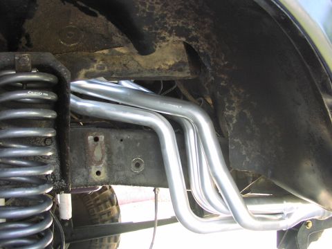 1979 Ford Bronco - Vehicle's undercarriage shows new exhaust headers and suspension components.