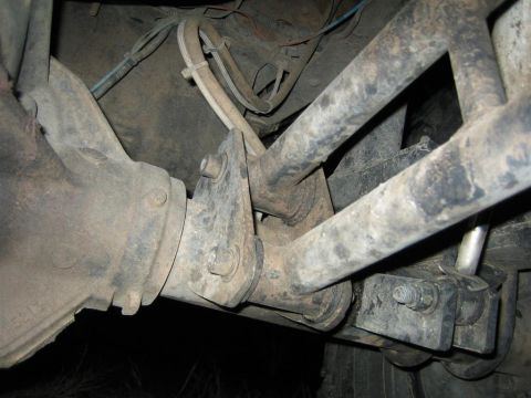 1991 Ford Bronco - Undercarriage view of a vehicle's suspension system, highlighting the mechanical components and wiring.