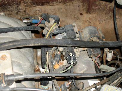 1993 Ford Bronco - Close-up view of engine wiring harness and fuel injectors, with a circled connection point.
