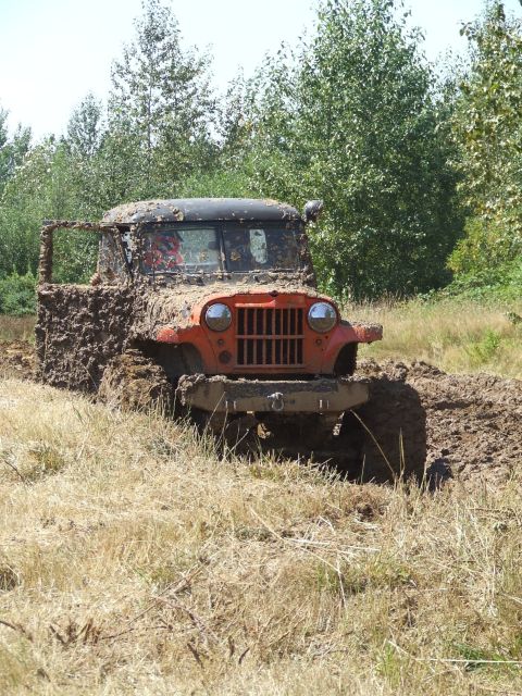 1977 Ford F-150 - This vehicle is deep in the mud, with only its front end and grille clearly visible.