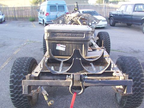 1978 Ford Bronco - The rear frame of a vehicle, fitted with an ActionPacker storage box, is shown. Other vehicles are parked in the background.