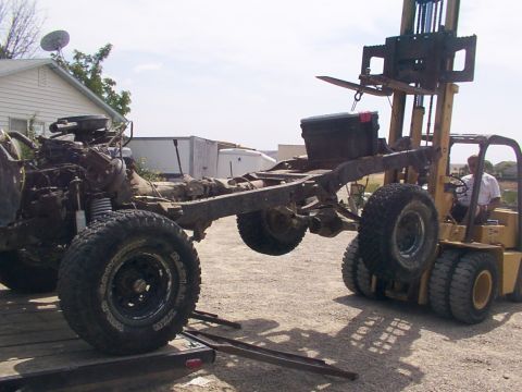 1978 Ford Bronco - Forklift moves the chassis of a 1978 Ford Bronco, likely for a restoration or build.