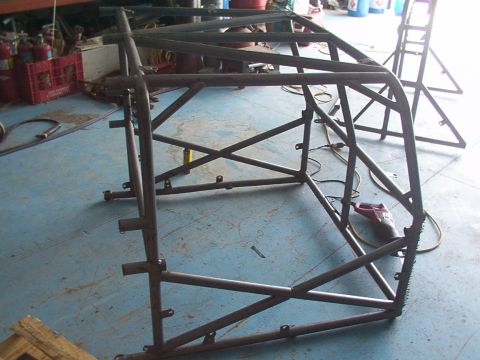 1978 Ford Bronco - A custom-fabricated roll cage structure is shown in a workshop setting, awaiting further modifications.