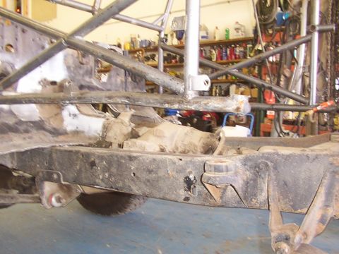 1978 Ford Bronco - Vehicle frame and roll cage construction in progress, showing chassis components and workshop background.