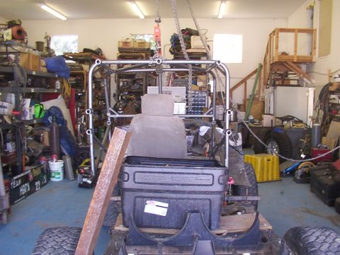1978 Ford Bronco - A vehicle is being worked on in a garage, with a roll cage being constructed around the seat and a toolbox in the back.
