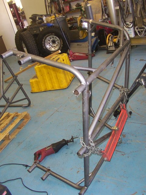 1978 Ford Bronco - Roll cage fabrication in progress, with tools and materials visible in the workshop.