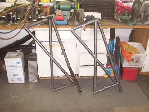 1978 Ford Bronco - Two custom metal frames are shown in a workshop setting, possibly for a vehicle build.