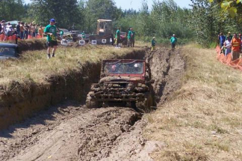 1977 Ford F-150 - An off-road vehicle navigates a challenging mud course during an event.