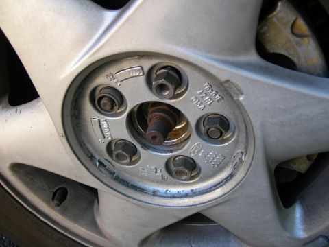 1992 Ford Taurus - Close-up of a silver alloy wheel showing lug nuts and manufacturing details, including the year 1992.
