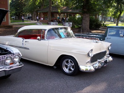 1972 Ford Ranchero - A cream-colored 1955 Chevrolet Bel Air is displayed outdoors, parked alongside other vehicles.