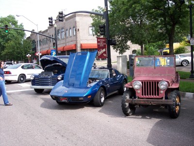 1972 Ford Ranchero - A blue Corvette and a red Jeep are parked on a street with their hoods open, suggesting a car show or gathering.