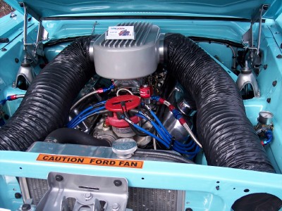 1972 Ford Ranchero - Customized engine bay of a 1972 Ford Ranchero, large black air intake hoses and a prominent 'CAUTION FORD FAN' decal.