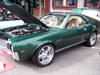 1972 Ford Ranchero - A green coupe with its hood open, revealing the engine, sits on display.