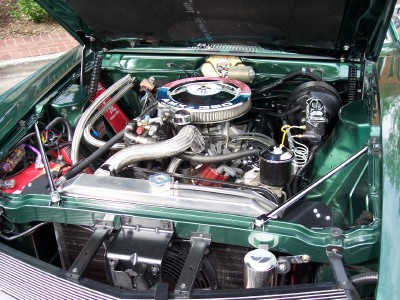 1972 Ford Ranchero - The detailed engine compartment of a green vehicle is shown with the hood open.