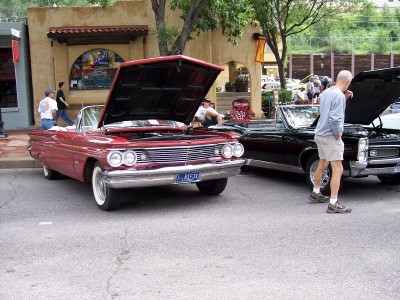 1972 Ford Ranchero - Two vintage convertibles displayed with their hoods open at an outdoor event.