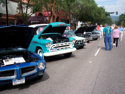 1972 Ford Ranchero - Several classic vehicles are displayed on a street, with their hoods open for viewing.