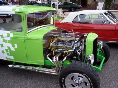 1972 Ford Ranchero - A custom hot rod with a vibrant green and white paint scheme is displayed alongside other vehicles.
