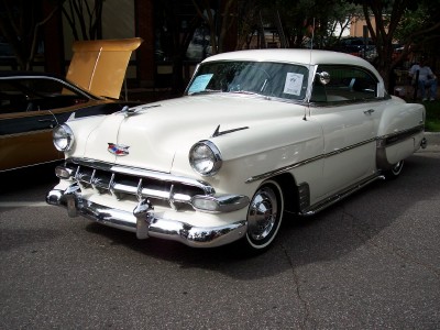 1972 Ford Ranchero - A white 1953 Chevrolet Bel Air coupe is parked on a street, with another vehicle visible behind it.