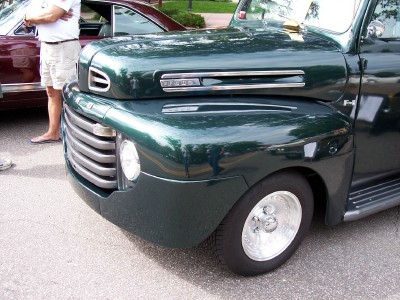 1972 Ford Ranchero - Front view of a dark green 1948 Ford F-series truck, with another vehicle visible behind.