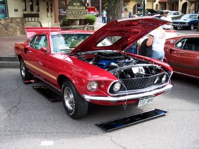 1972 Ford Ranchero - A red 1969 Ford Mustang Mach 1 is displayed with its hood open, revealing the engine bay.