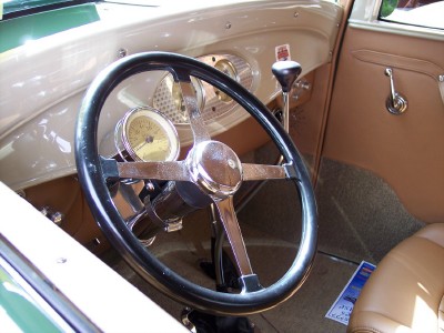1972 Ford Ranchero - The interior of a classic car features a large steering wheel and tan upholstery.