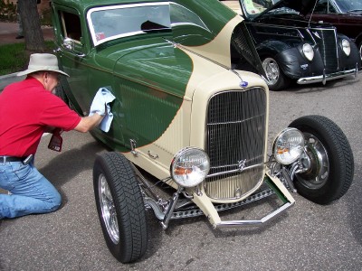 1972 Ford Ranchero - A man polishes a custom hot rod with a two-tone green and tan paint scheme, parked next to another classic car.