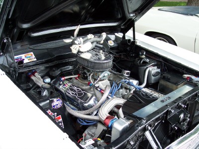 1972 Ford Ranchero - Engine bay view of a modified V8, with another vehicle visible in the background.