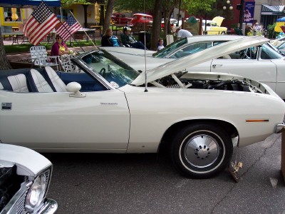 1972 Ford Ranchero - White 1970 Plymouth Barracuda convertible with hood open, parked at an outdoor event.