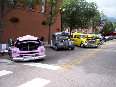1972 Ford Ranchero - Classic cars lined up on a street, hoods open, at what appears to be a car show.