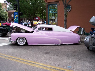 1972 Ford Ranchero - A customized pink coupe with its hood and trunk open sits on a street.