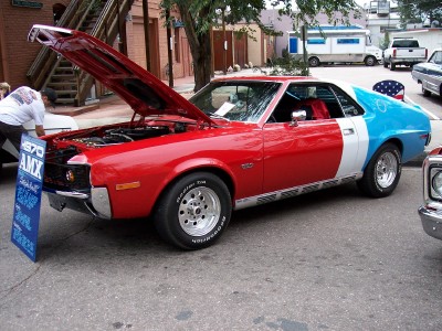 1972 Ford Ranchero - A 1970 AMC Javelin displays its patriotic colors and open engine compartment at a car show.