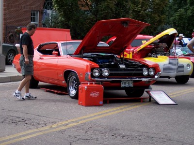 1972 Ford Ranchero - An orange Ford Ranchero is displayed with its hood open, alongside another vehicle.
