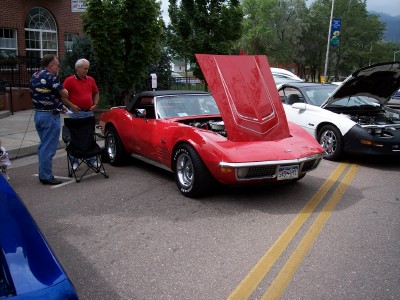 1972 Ford Ranchero - Red convertible parked on street with hoods open, other cars nearby.