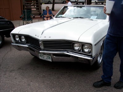 1972 Ford Ranchero - White 1967 Buick Skylark convertible parked outdoors, front view.