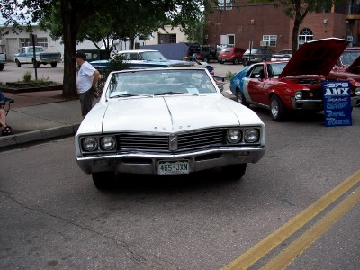 1972 Ford Ranchero - A white convertible is parked on a street, with other vehicles visible in the background.