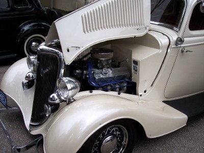 1972 Ford Ranchero - Customized 1930s hot rod with its hood up, revealing the engine bay and V8 motor.