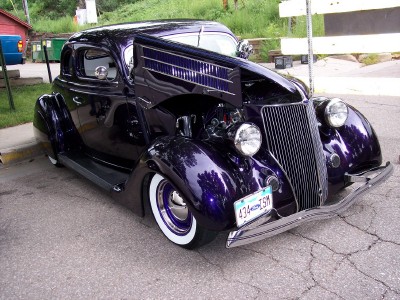 1972 Ford Ranchero - Custom purple coupe with exposed engine and classic styling, parked outdoors.