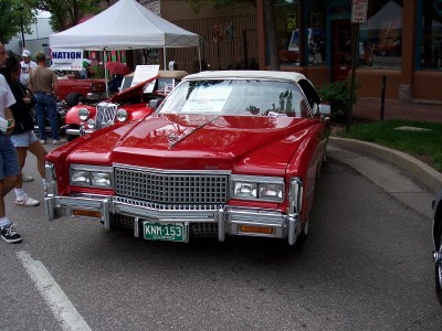 1972 Ford Ranchero - A red convertible with a white top is displayed at an outdoor event.