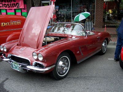 1972 Ford Ranchero - Red 1961 Chevrolet Corvette convertible with hood open, parked on a street.