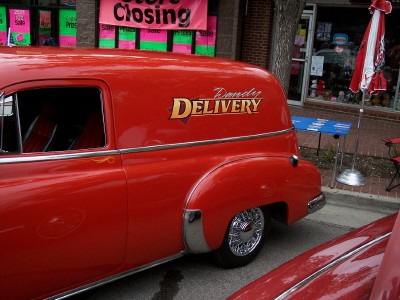 1972 Ford Ranchero - A vintage red delivery van is parked in front of a store with a 'Store Closing' banner.