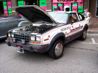 1972 Ford Ranchero - This AMC Spirit features racing decals and its hood is open, revealing the engine compartment.