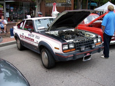 1972 Ford Ranchero - AMC Spirit with hood open, showing engine. Carrera Panamericana livery visible on door.