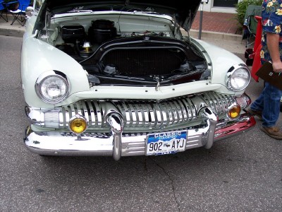 1972 Ford Ranchero - This 1950 Mercury features a distinctive chrome grille and its hood is open, revealing the engine compartment.