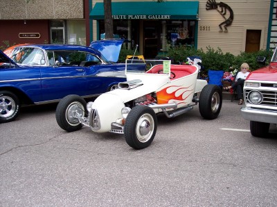 1972 Ford Ranchero - A custom hot rod with flame graphics is displayed alongside other vehicles.