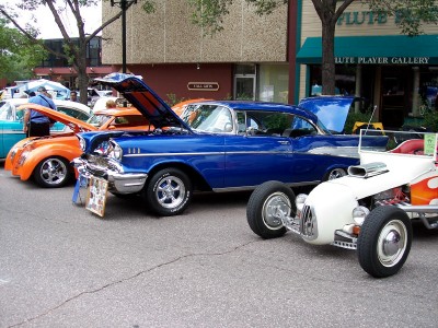 1972 Ford Ranchero - Several classic cars are lined up on a street, with their hoods open for display.