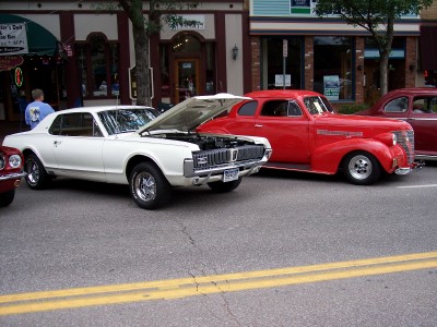 1972 Ford Ranchero - White 1968 Mercury Cougar XR7 and a red 1930s sedan at a car show.