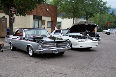 1972 Ford Ranchero - A two-tone 1965 Dodge Coronet is parked next to other vehicles with hoods open.