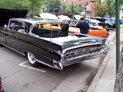 1972 Ford Ranchero - A classic black Lincoln Continental is parked on the street, with other vehicles visible behind it.