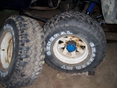 1983 Ford Bronco - Two General Grabber MT tires and white rims are shown, with one tire's sidewall text partially visible.
