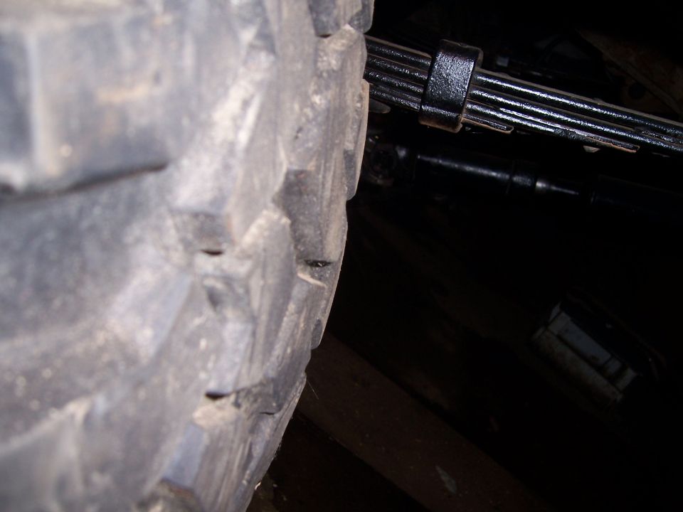 Close-up of a tire and leaf spring assembly